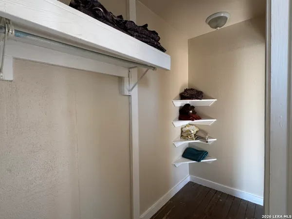 an empty room with windows and closet