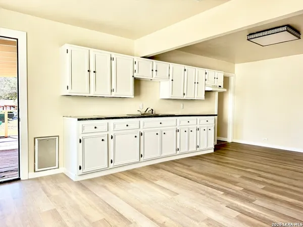 a view of kitchen with cabinets