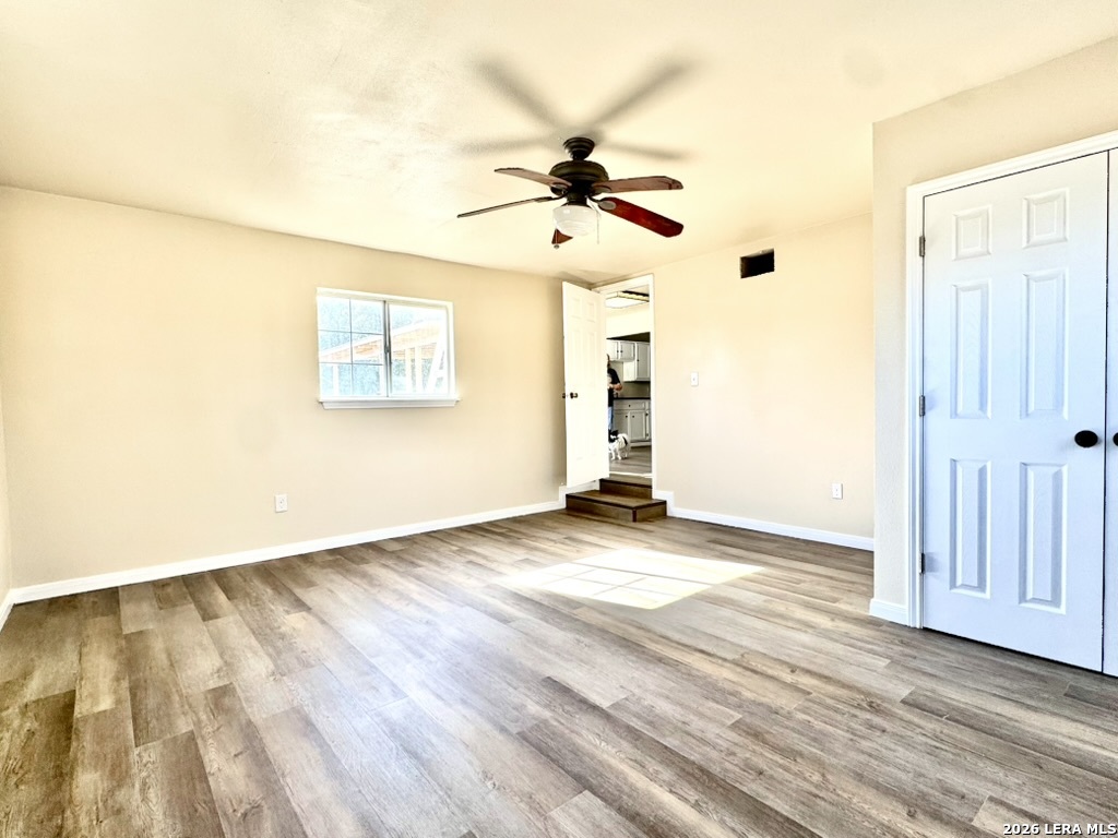 19524 South Benton Street Lytle, TX 78052 - Photo 9 of 22 wooden floor in an empty room with a window