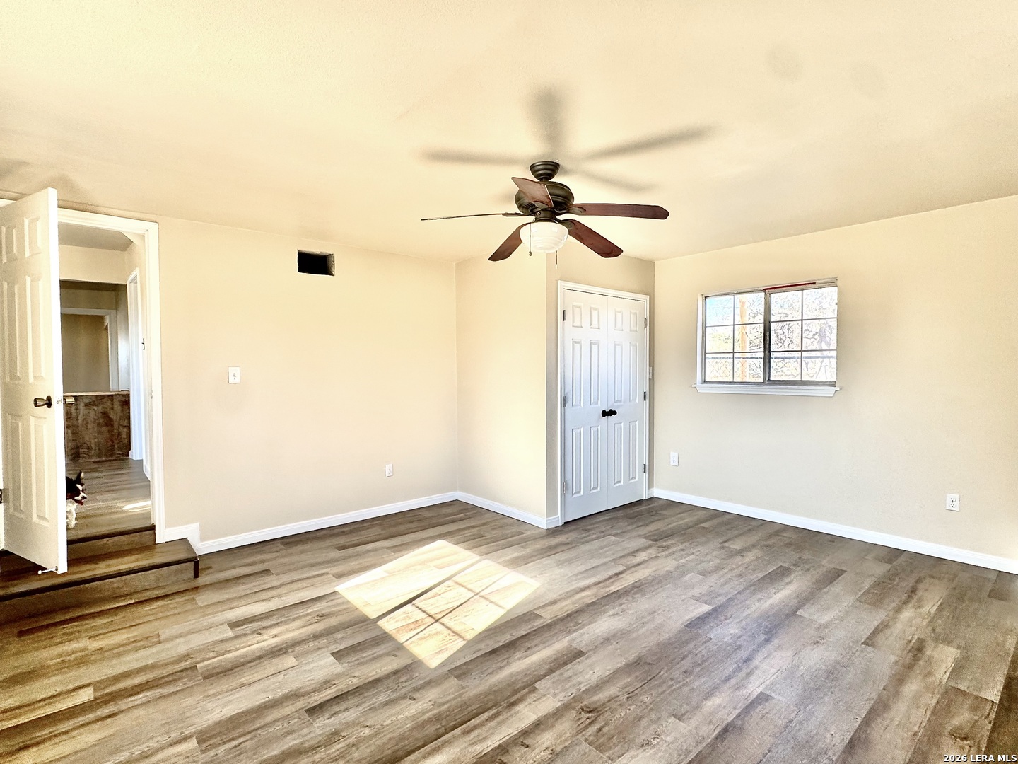 19524 South Benton Street Lytle, TX 78052 - Photo 10 of 22 an empty room with wooden floor and windows