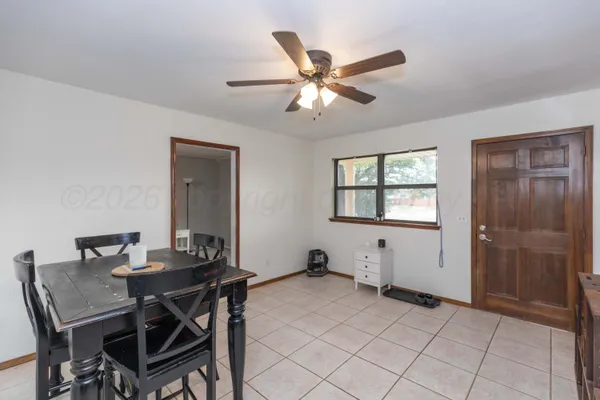 a view of a dining room with furniture and a chandelier fan