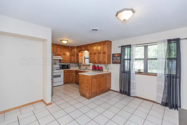 a kitchen with a sink stove and refrigerator