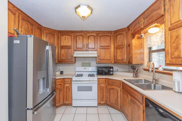 a view of a kitchen with a sink a window and cabinets