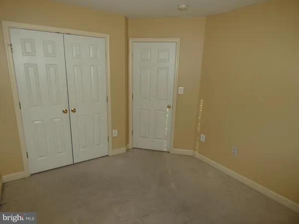 an empty room with closet area