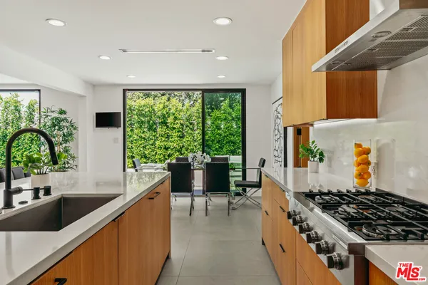 a kitchen with a large window in it and kitchen island