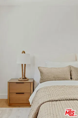 a bedroom with a bed and night stand