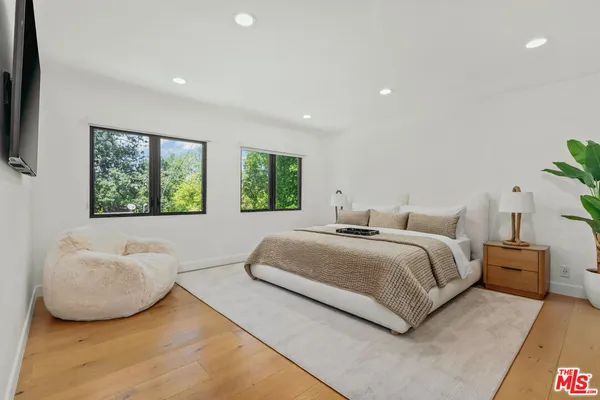 a bedroom with a bed and a couch