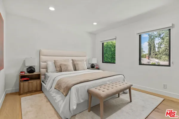 a bedroom with a bed and a painting on the wall
