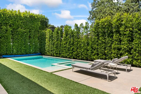 a view of a backyard with swimming pool