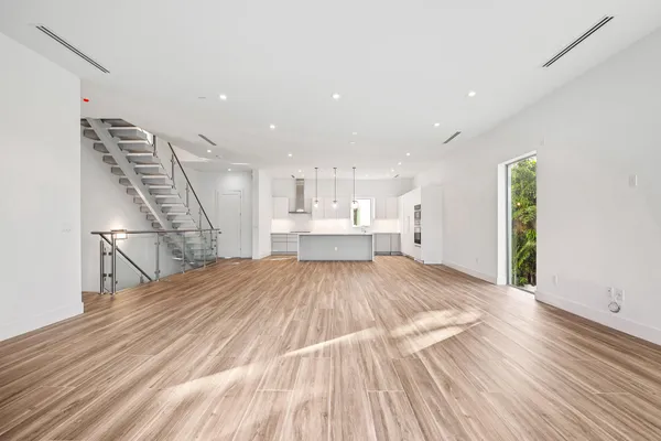 a view of kitchen and hall with wooden floor