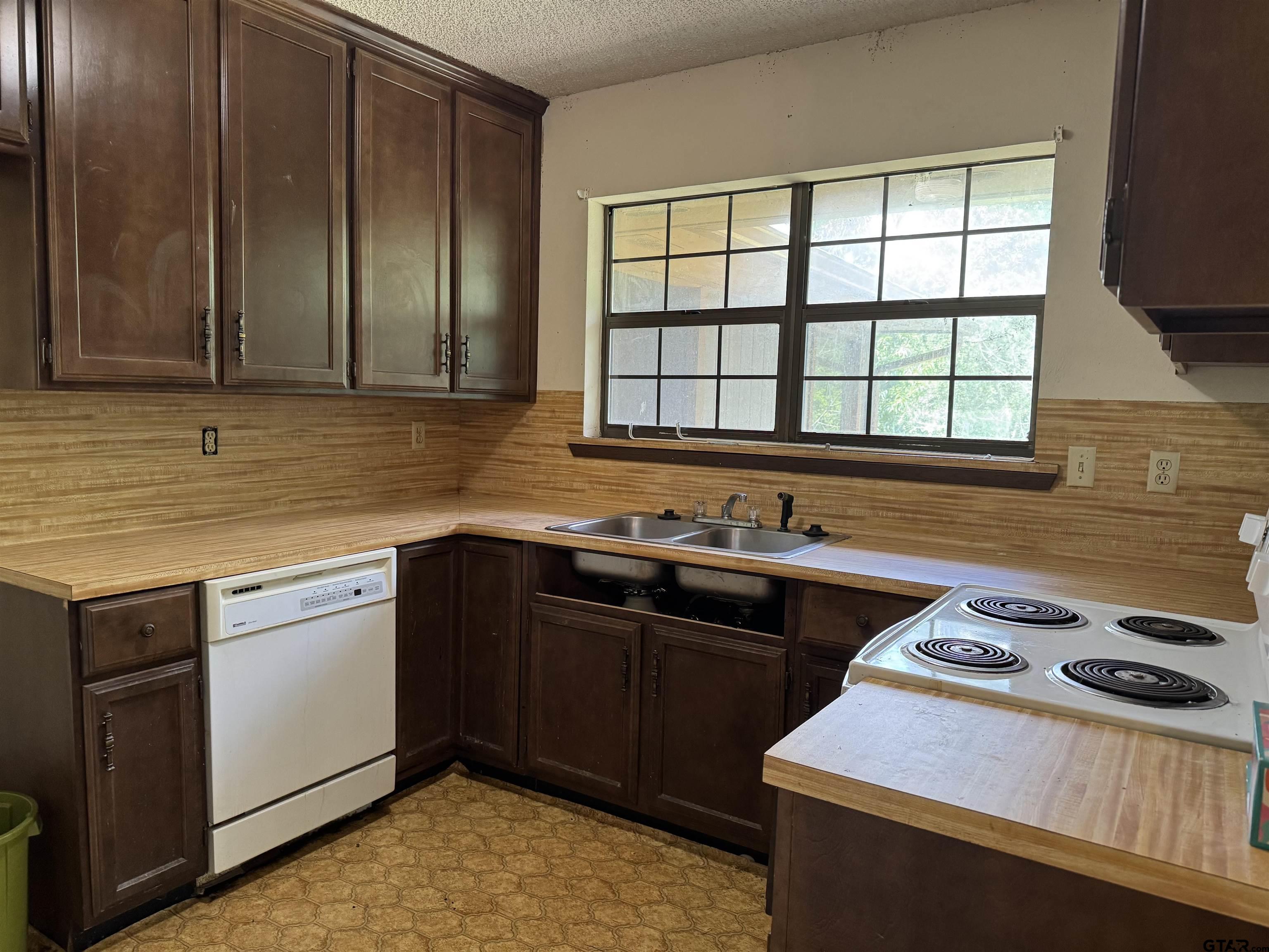 289 Llano Bend Holly Lake Ranch, TX 75765 - Photo 6 of 48 a kitchen with a sink stove and cabinets