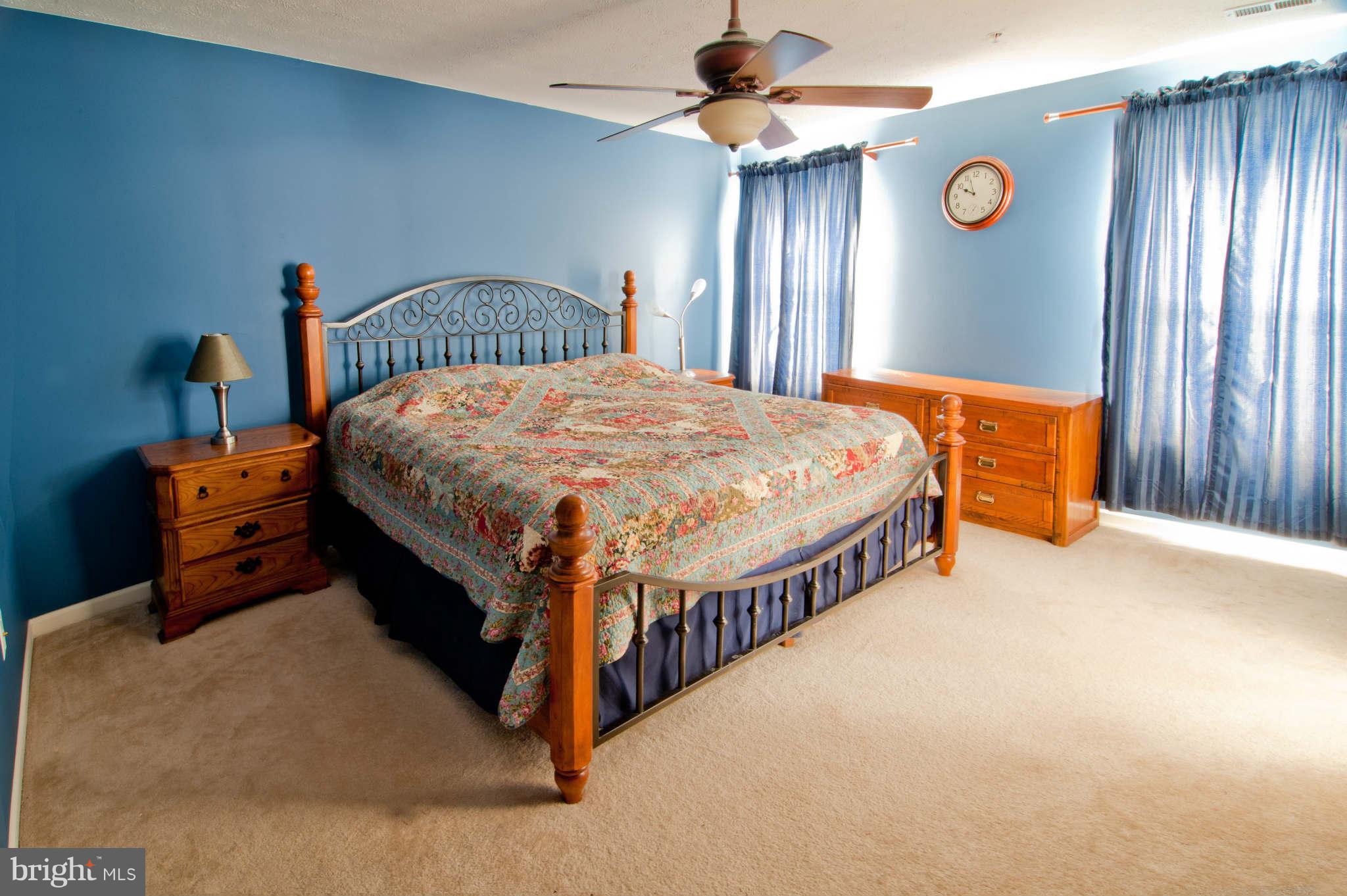 9661 Biggs Road Baltimore, MD 21220 - Photo 15 of 25 a bed sitting in a spacious bedroom next to a window
