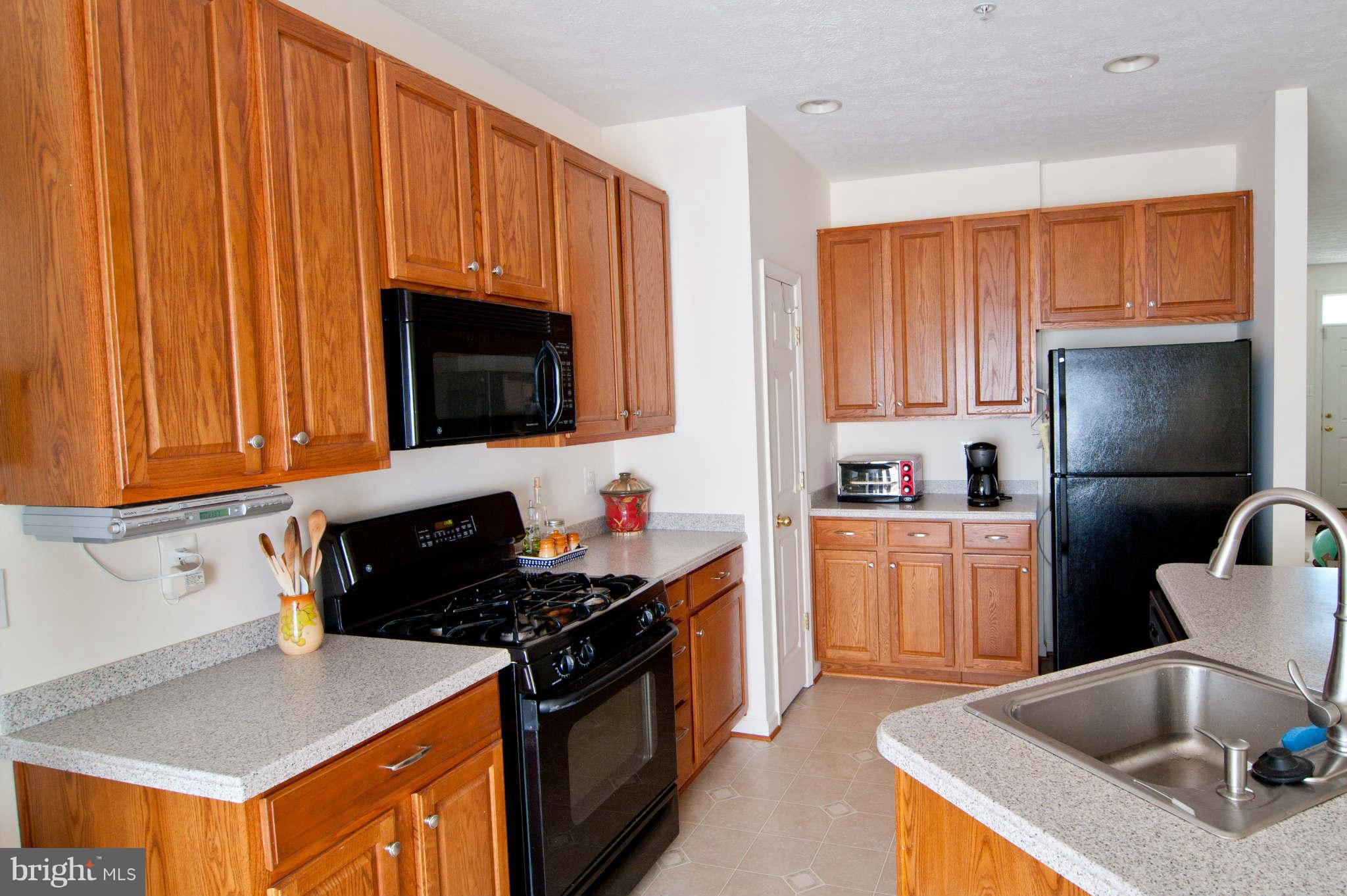 9661 Biggs Road Baltimore, MD 21220 - Photo 9 of 25 a kitchen with granite countertop a sink stove and refrigerator