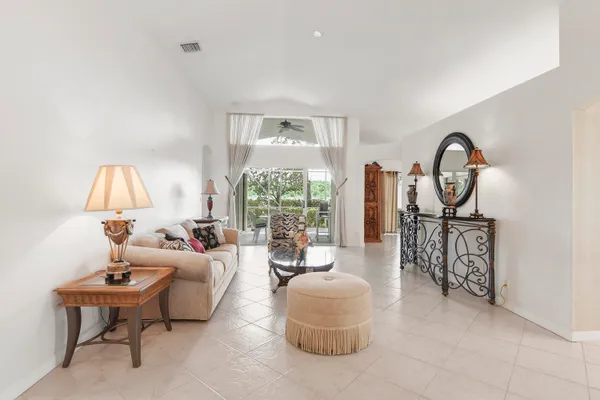 a living room with furniture a table and a large window