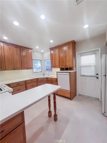 a kitchen with stainless steel appliances granite countertop refrigerator sink and cabinets