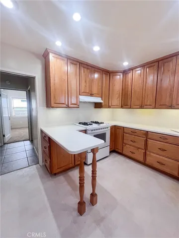 a spacious kitchen with stainless steel appliances granite countertop a sink counter space and cabinets