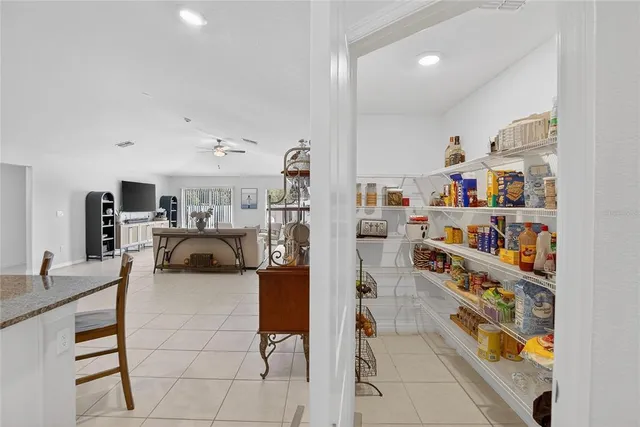 a living room with furniture and a book shelf