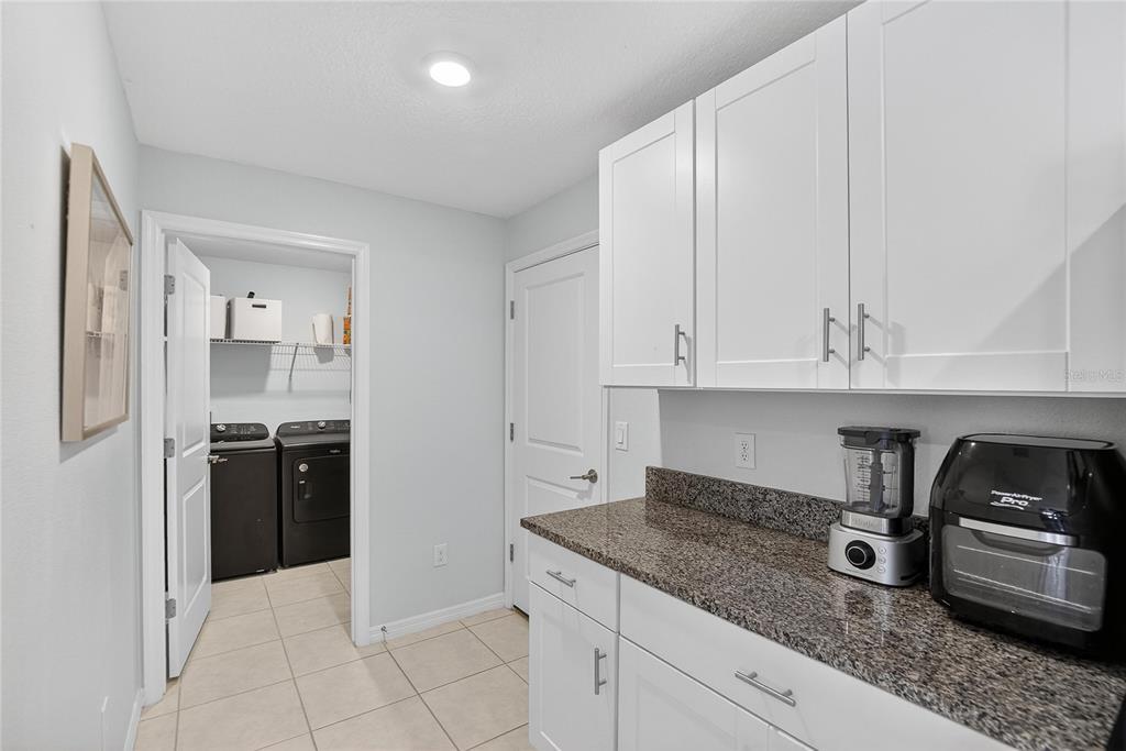2950 Flying Blackbird Road Bartow, FL 33830 - Photo 16 of 41 a kitchen with granite countertop white cabinets and stainless steel appliances