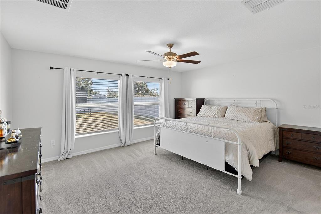 2950 Flying Blackbird Road Bartow, FL 33830 - Photo 23 of 41 a bedroom with a large bed and a chandelier