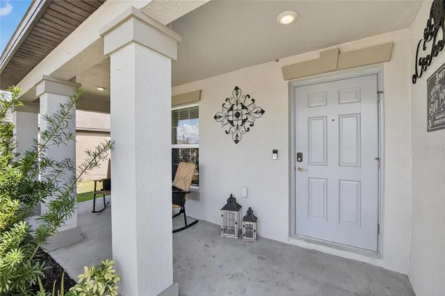 an entryway with a flower pot and a bookshelf