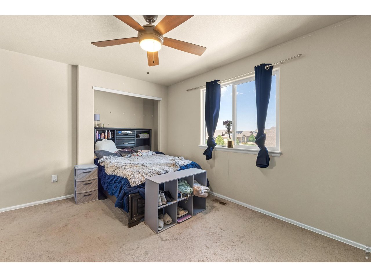 8847 16th St Road Greeley, CO 80634 - Photo 25 of 38 a room with a bed and a ceiling fan