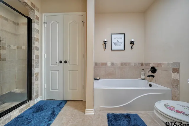 a bathroom with a bathtub and a shower