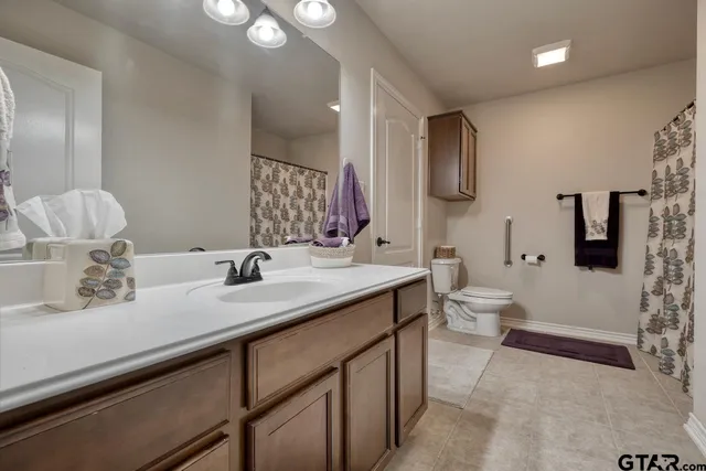 a bathroom with a double vanity sink toilet and shower