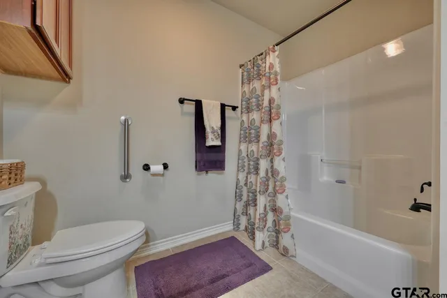 a bathroom with a toilet and shower