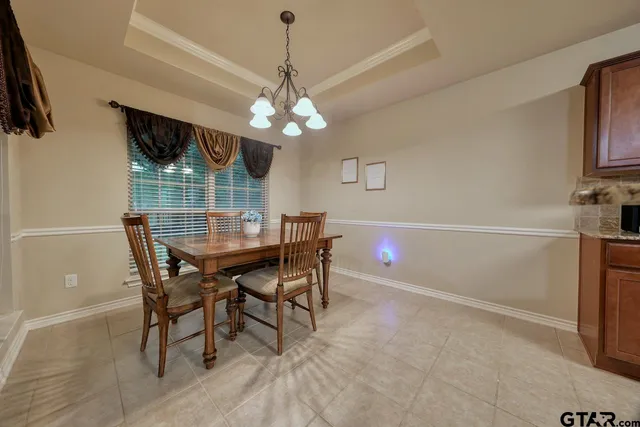a view of a dining room with furniture and chandelier