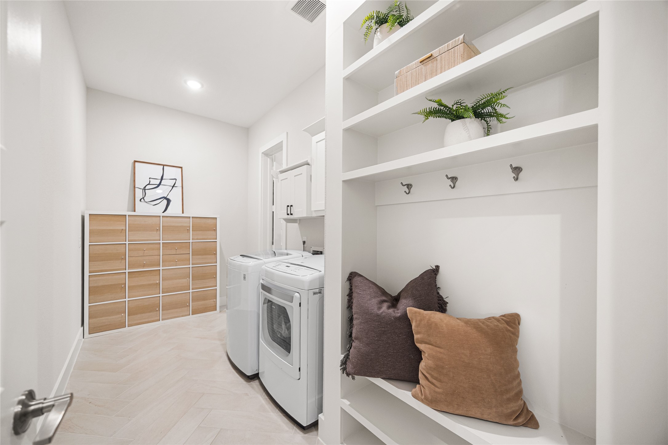 4130 Pleasant Ridge Drive Spring, TX 77386 - Photo 27 of 46 The spacious first-floor laundry room offers abundant storage and workspace, making everyday chores both convenient and efficient.