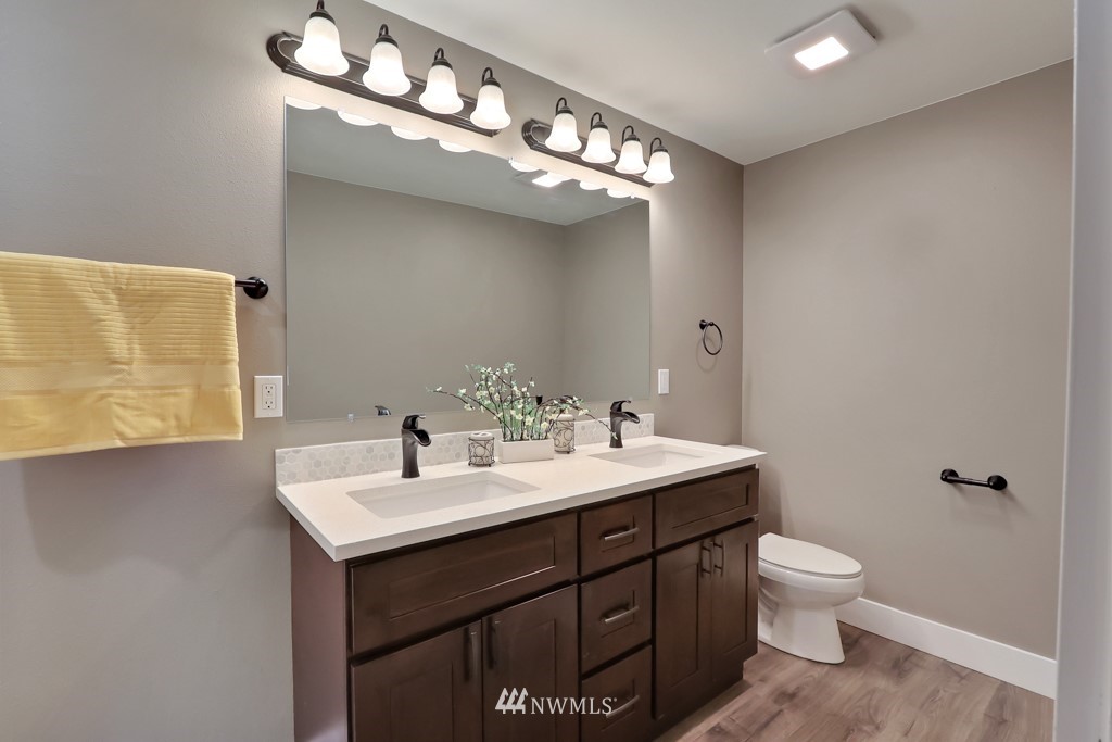 14628 164th Place Southeast Renton, WA 98059 - Photo 22 of 34 a bathroom with a toilet a sink and mirror