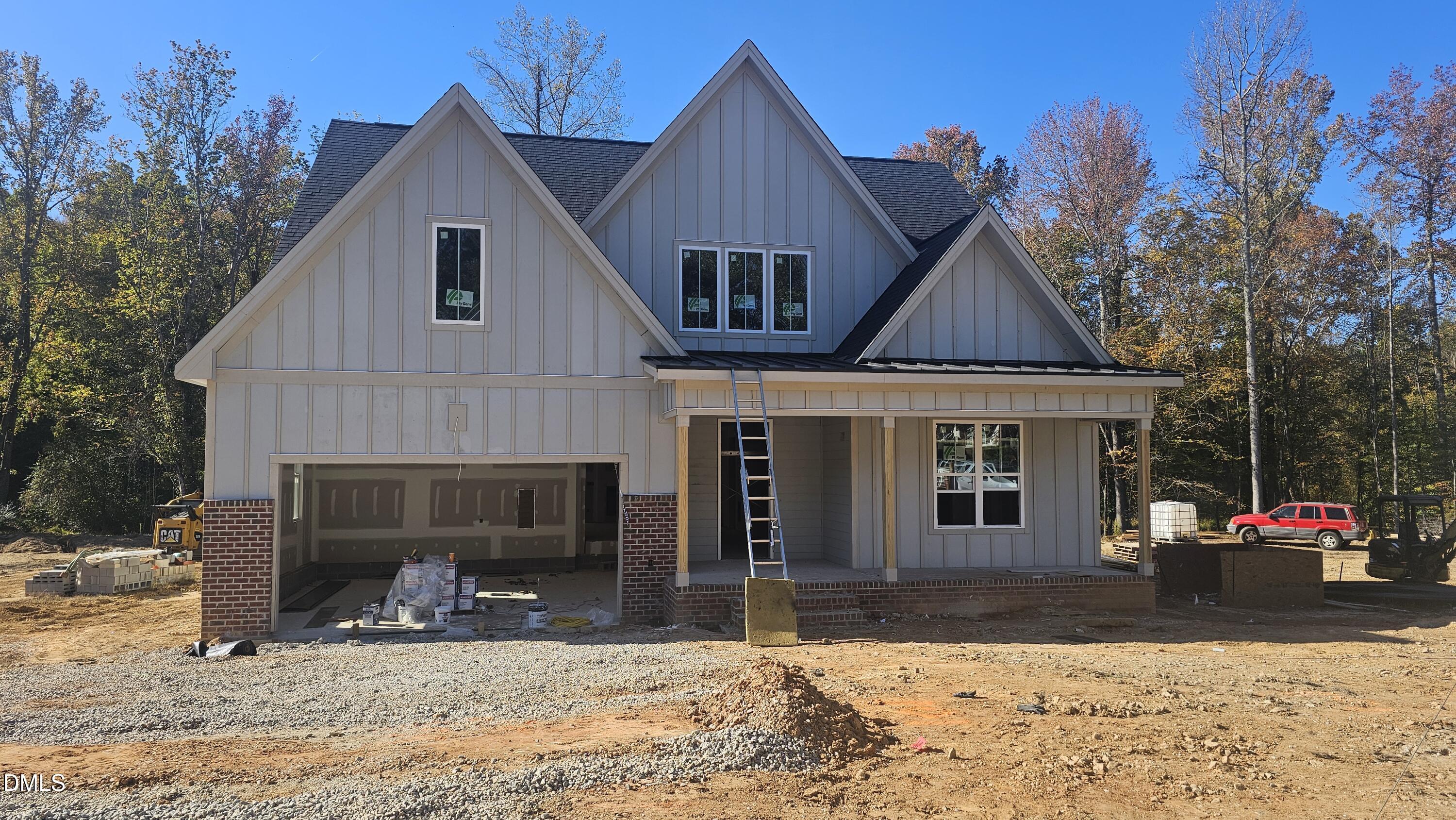 a front view of a house with a yard covered with snow in front of house