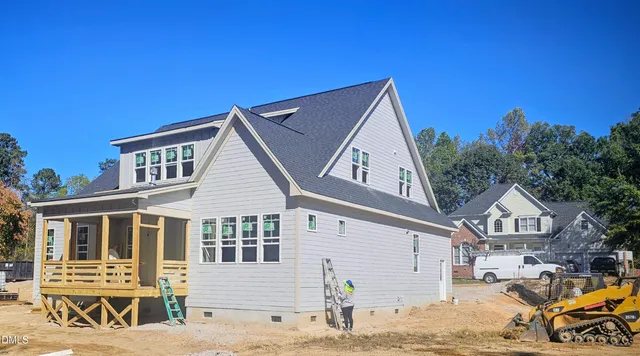 a view of a house with wooden fence