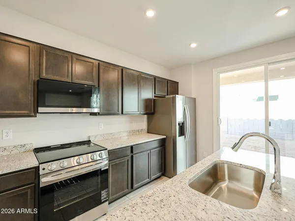 a kitchen with a stove a sink and a microwave