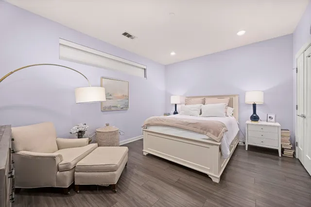 a bedroom with a bed and a mirror