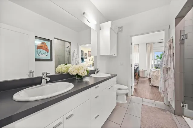 a bathroom with a granite countertop sink a toilet and a mirror