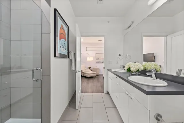 a en suite bathroom with a granite countertop sink and a mirror