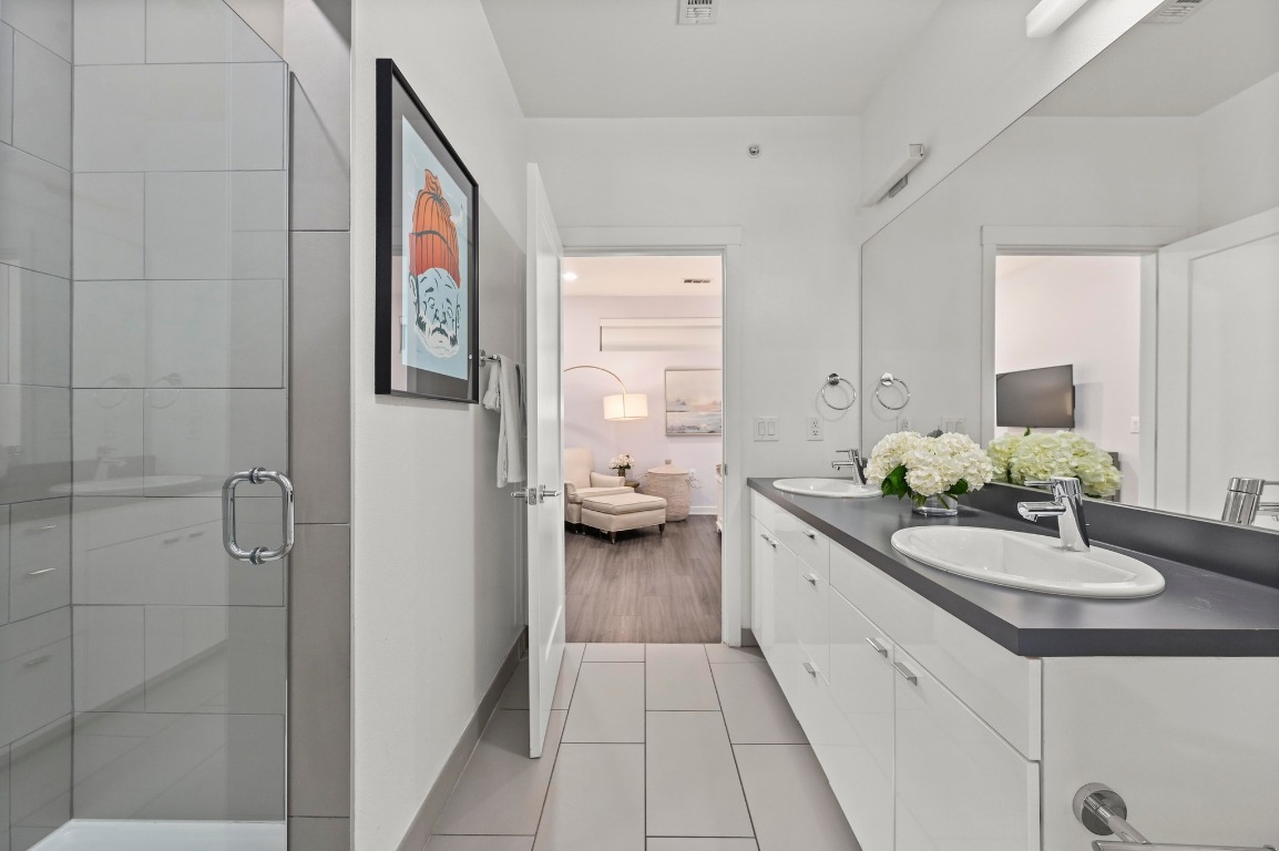 4361 South Congress Avenue, Unit 427 Austin, TX 78745 - Photo 17 of 33 a en suite bathroom with a granite countertop sink and a mirror