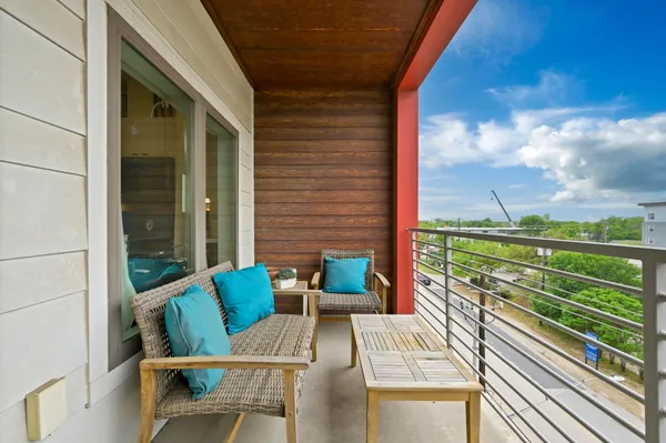 a view of balcony with chairs and a potted plant