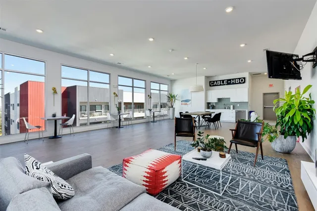 a living room with furniture and floor to ceiling window