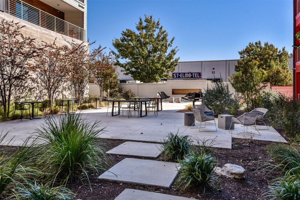4361 South Congress Avenue, Unit 427 Austin, TX 78745 - Photo 29 of 33 a view of a patio with table and chairs potted plants and palm tree