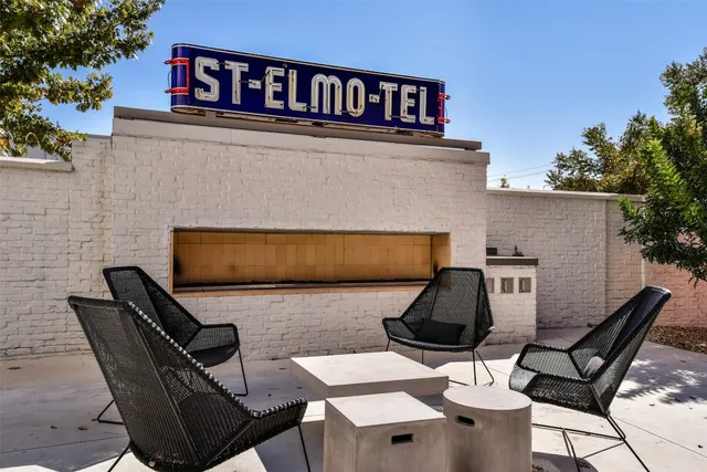 a balcony with table and chairs