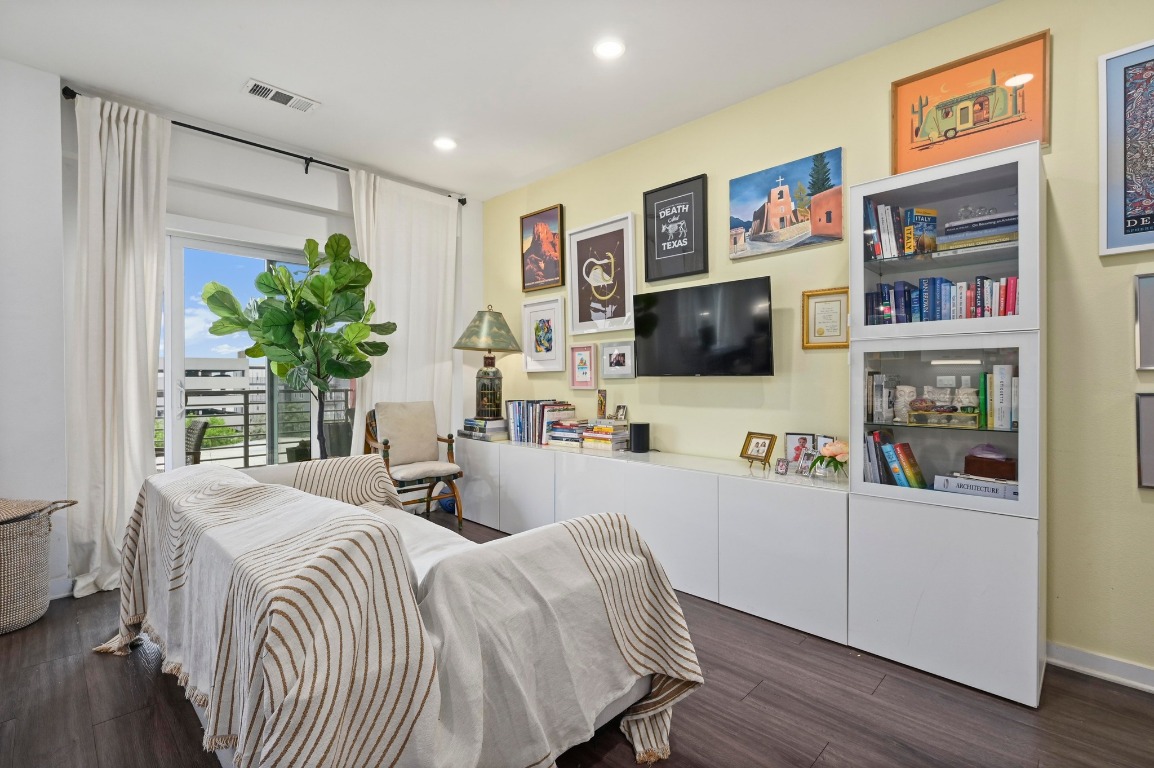 4361 South Congress Avenue, Unit 427 Austin, TX 78745 - Photo 5 of 33 a bedroom with furniture and a flat screen tv