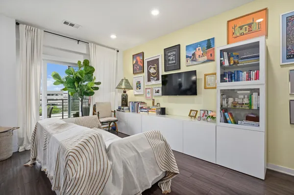 a bedroom with furniture and a flat screen tv