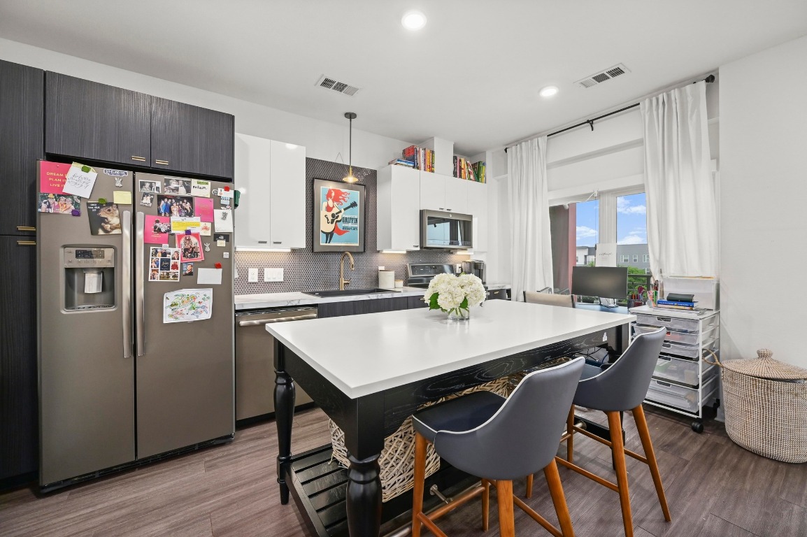 4361 South Congress Avenue, Unit 427 Austin, TX 78745 - Photo 9 of 33 a view of a dining room with furniture and wooden floor