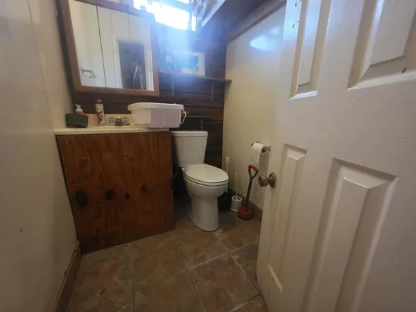 a bathroom with a sink toilet mirror and vanity