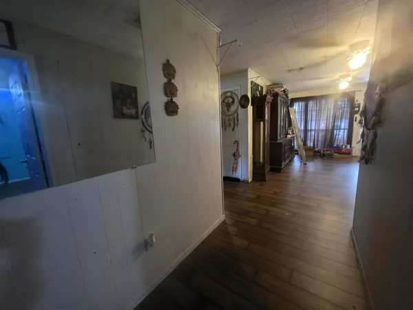 a view of a hallway with wooden shelves