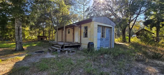 a backyard of a house with table and chairs