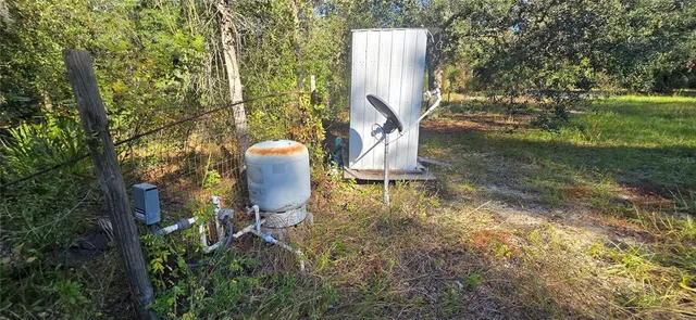 a backyard of a house with table and chairs