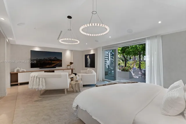 a large white bathroom with a large mirror vanity and a shower